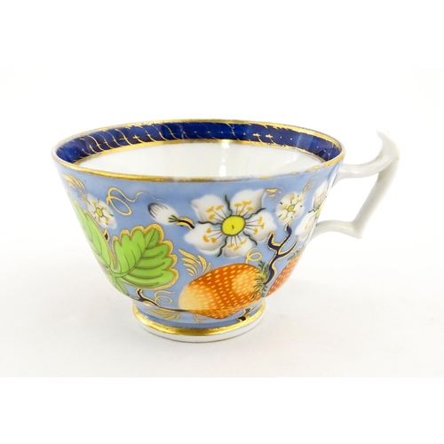 106 - A 19thC tea cup and saucer decorated with strawberry and flower detail. Cup approx. 2 1/4