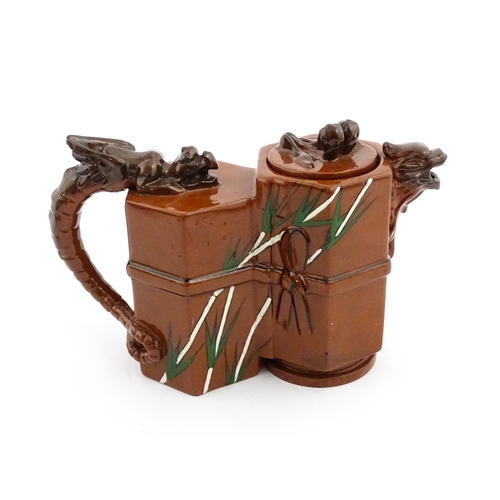 108 - A Watcombe pottery terracotta Aesthetic Movement teapot designed by Christopher Dresser with dragon ... 