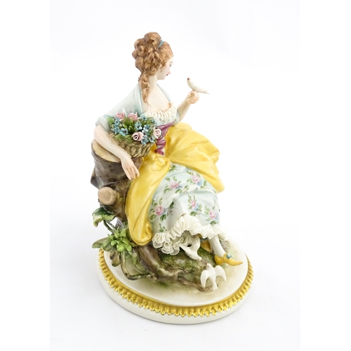 124 - An Italian Capodimonte figure depicting a seated lady with birds, by Giuseppe Cappe. With hand paint... 