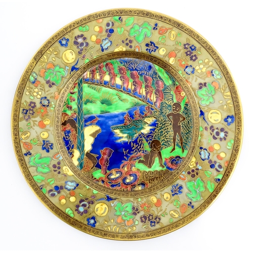 131 - A Wedgwood Fairyland lustre plate decorated in the Imps on a Bridge - Roc Centre pattern, designed b... 