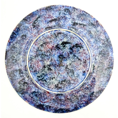 131 - A Wedgwood Fairyland lustre plate decorated in the Imps on a Bridge - Roc Centre pattern, designed b... 