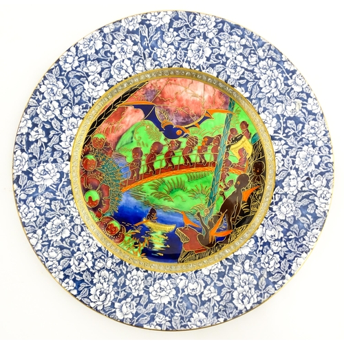 134 - A Wedgwood Fairyland lustre plate decorated in the Imps on a Bridge - Roc Centre pattern, designed b... 