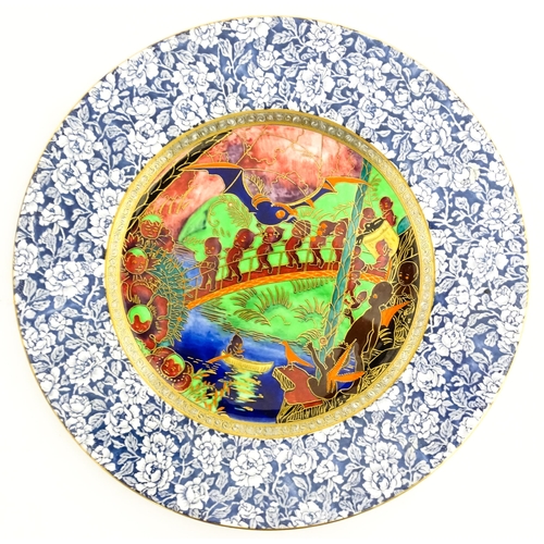 134 - A Wedgwood Fairyland lustre plate decorated in the Imps on a Bridge - Roc Centre pattern, designed b... 