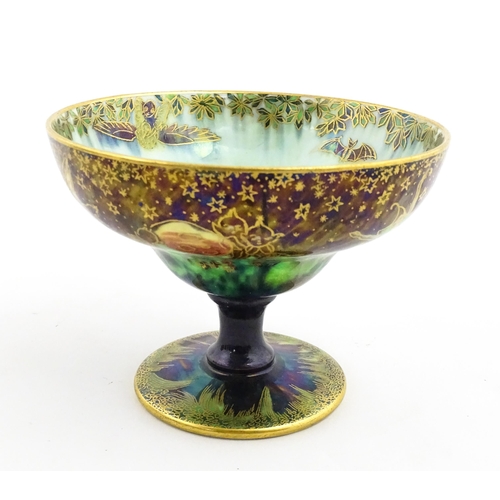 135 - A Wedgwood fairyland lustre pedestal bowl decorated with fairies, elves and imps, designed by Daisy ... 