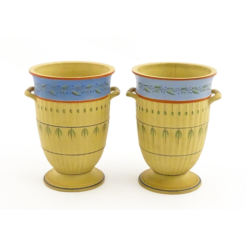 139 - A pair of early Wedgwood caneware vases, the fluted bodies with twin handles and banded foliate deco... 