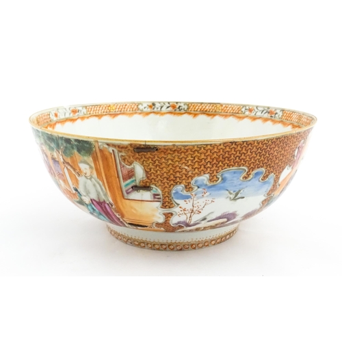 17 - A Chinese Export punch bowl decorated in the Mandarin palette with figures in a landscape with river... 