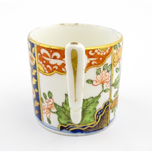 99 - A Derby coffee cup and saucer decorated in the Imari palette with flowers and foliage. Both pieces m... 