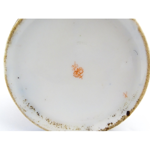 99 - A Derby coffee cup and saucer decorated in the Imari palette with flowers and foliage. Both pieces m... 