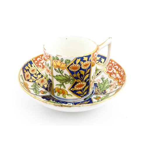 99 - A Derby coffee cup and saucer decorated in the Imari palette with flowers and foliage. Both pieces m... 