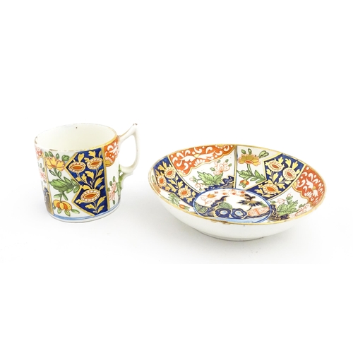 99 - A Derby coffee cup and saucer decorated in the Imari palette with flowers and foliage. Both pieces m... 