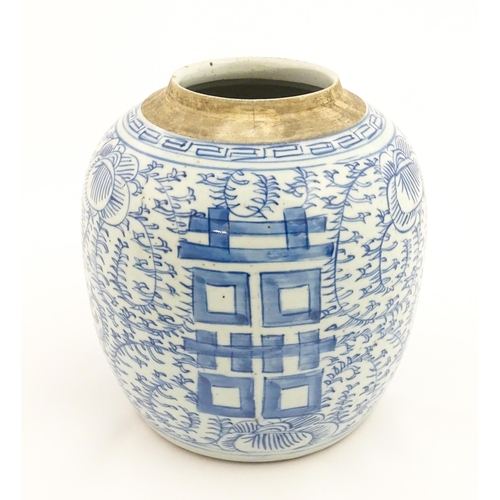 14 - A Chinese blue and white jar with brushwork decoration depicting flowers and foliage. Approx. 8 1/2