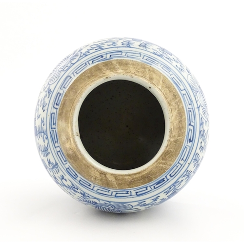 14 - A Chinese blue and white jar with brushwork decoration depicting flowers and foliage. Approx. 8 1/2