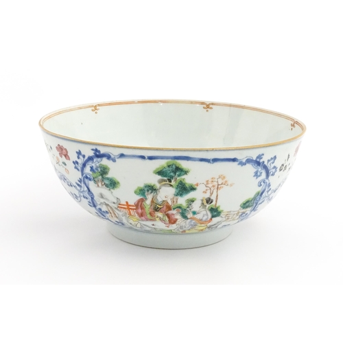 3 - A Chinese Export famille rose punch bowl decorated with two figures and a dog, birds, flowers and fo... 