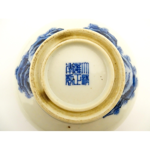 33 - A Chinese blue and white ink box of circular form decorated with figures in a landscape scene with a... 