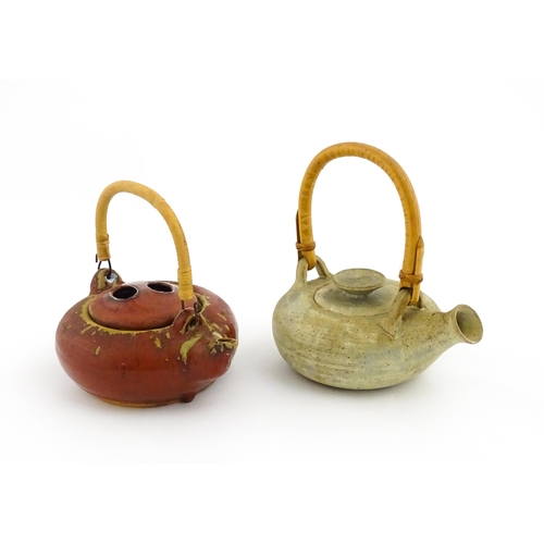 34 - Two Japanese stoneware studio pottery teapots with swing handles. Approx. 7 1/2