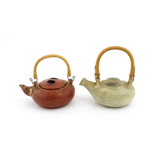 34 - Two Japanese stoneware studio pottery teapots with swing handles. Approx. 7 1/2