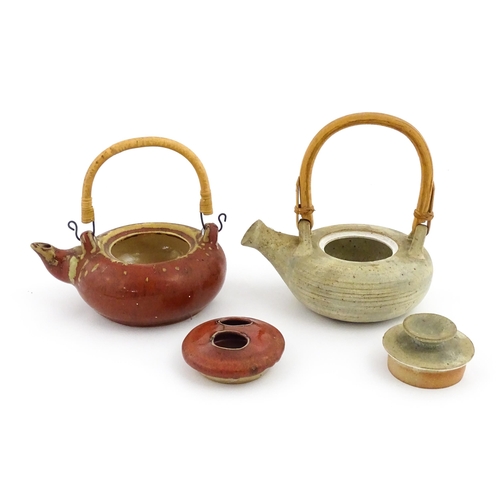 34 - Two Japanese stoneware studio pottery teapots with swing handles. Approx. 7 1/2