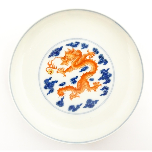 35 - A Chinese plate with decorated with a dragon and flaming pearl, the reverse with further dragon and ... 