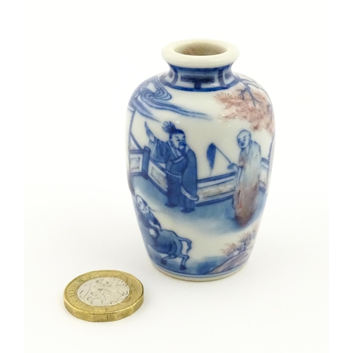 36 - A small Chinese blue and white vase depicting figures in a landscape. Approx. 2 3/4