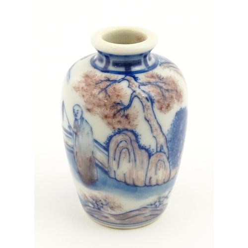 36 - A small Chinese blue and white vase depicting figures in a landscape. Approx. 2 3/4