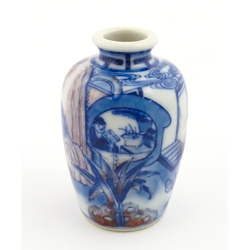 36 - A small Chinese blue and white vase depicting figures in a landscape. Approx. 2 3/4