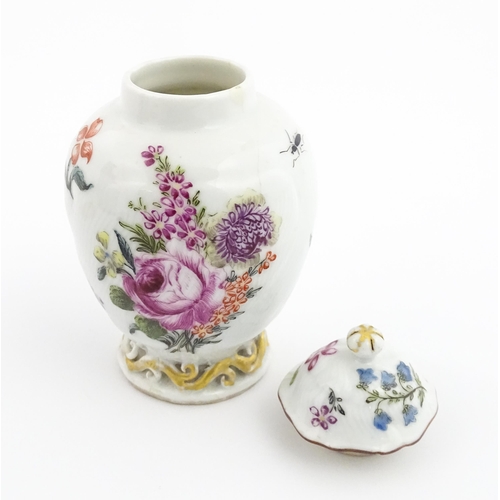 4 - A Chinese tea caddy / canister of vase and cover form with hand painted decoration depicting flowers... 