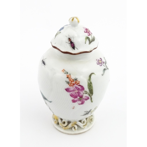 4 - A Chinese tea caddy / canister of vase and cover form with hand painted decoration depicting flowers... 