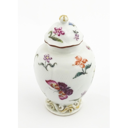 4 - A Chinese tea caddy / canister of vase and cover form with hand painted decoration depicting flowers... 