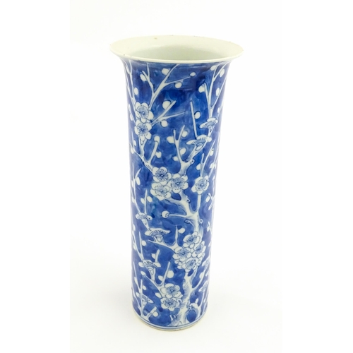 5 - A Chinese blue and white vase of cylindrical vase decorated with prunus blossom. Character marks und... 