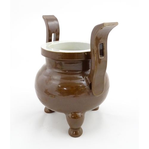 51 - A large Chinese censer with brown ground and twin upright handles. Impressed Character marks to rim.... 