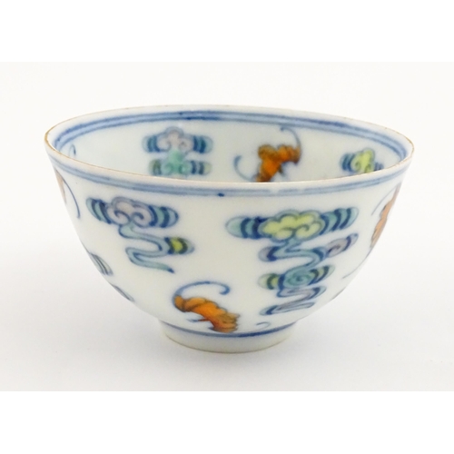 52 - A Chinese Docai tea bowl decorated with bats and stylised clouds. Character marks under. Approx. 2