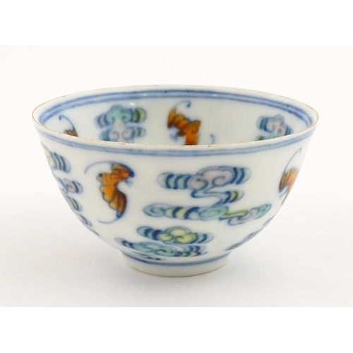 52 - A Chinese Docai tea bowl decorated with bats and stylised clouds. Character marks under. Approx. 2