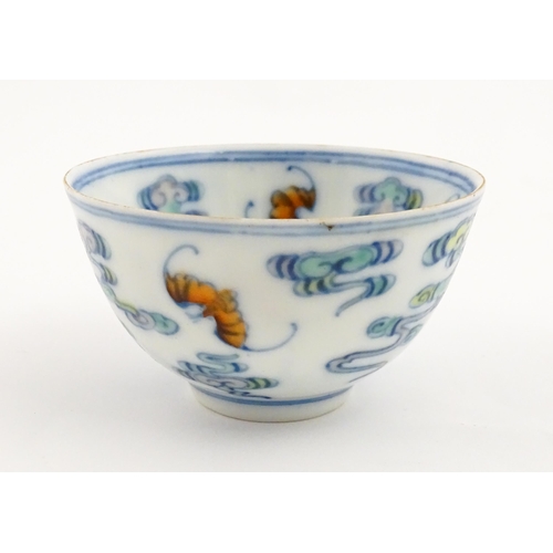 52 - A Chinese Docai tea bowl decorated with bats and stylised clouds. Character marks under. Approx. 2