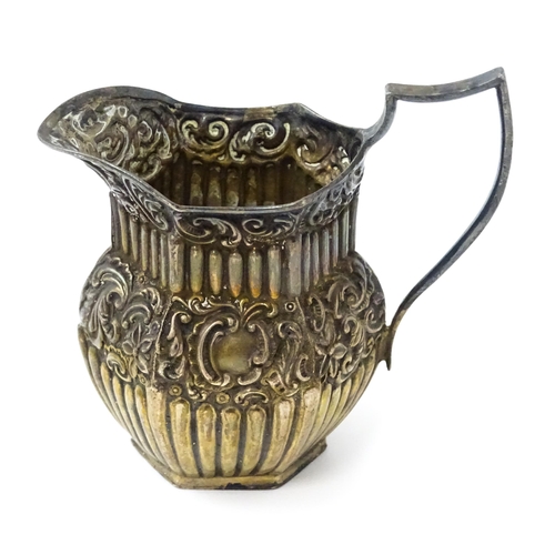 344 - A Victorian silver cream jug with embossed decoration hallmarked Birmingham 1887, maker Barker Broth... 