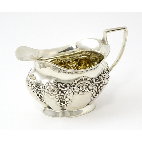 346 - A silver cream jug with embossed decoration hallmarked Birmingham 1901, maker William Aitken. Approx... 