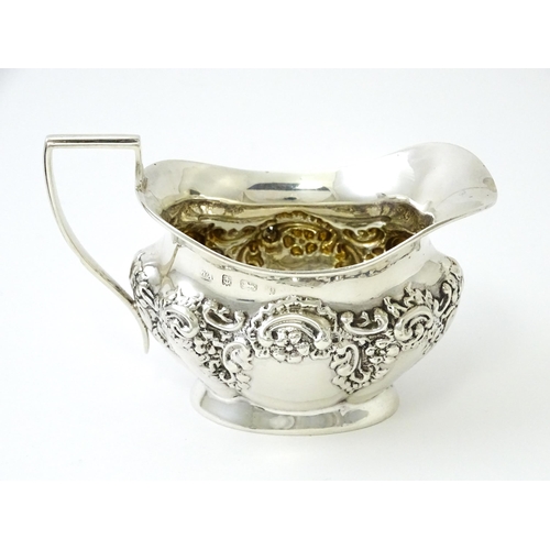 346 - A silver cream jug with embossed decoration hallmarked Birmingham 1901, maker William Aitken. Approx... 