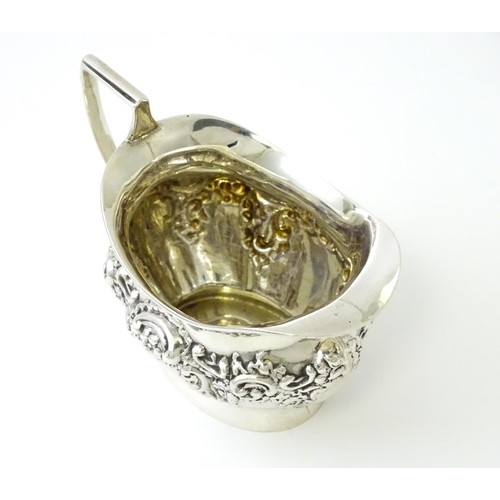 346 - A silver cream jug with embossed decoration hallmarked Birmingham 1901, maker William Aitken. Approx... 