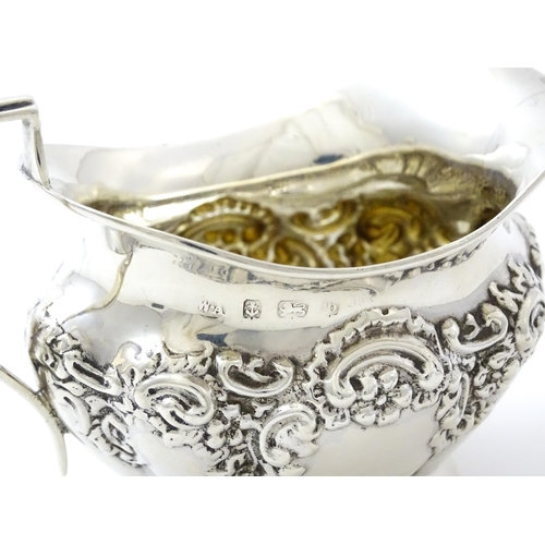 346 - A silver cream jug with embossed decoration hallmarked Birmingham 1901, maker William Aitken. Approx... 