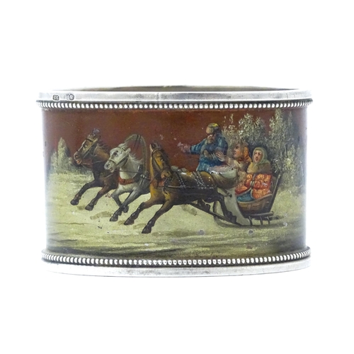 347 - A Russian silver napkin ring with lacquered and hand painted decoration depicting figures in a troik... 