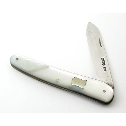 349 - A silver folding fruit knife with mother of pearl handle, hallmarked Sheffield 1927, maker Walker & ... 