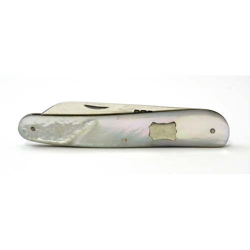 349 - A silver folding fruit knife with mother of pearl handle, hallmarked Sheffield 1927, maker Walker & ... 