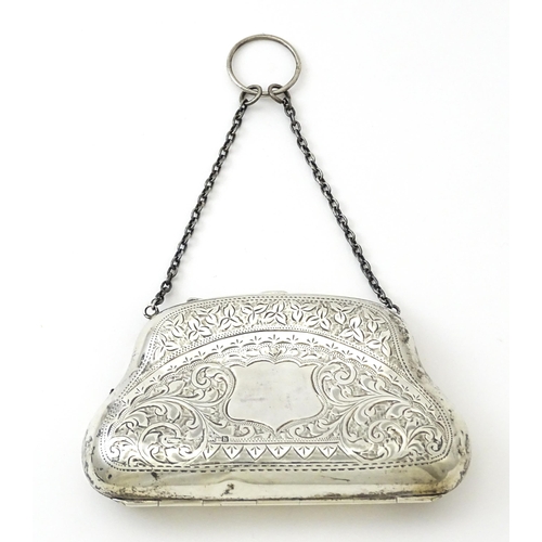 353 - A silver purse with engraved decoration and hanging chain, hallmarked Birmingham 1907. Approx. 4 1/2... 