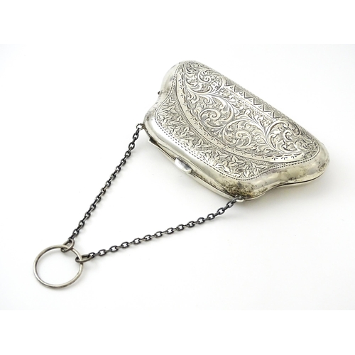 353 - A silver purse with engraved decoration and hanging chain, hallmarked Birmingham 1907. Approx. 4 1/2... 