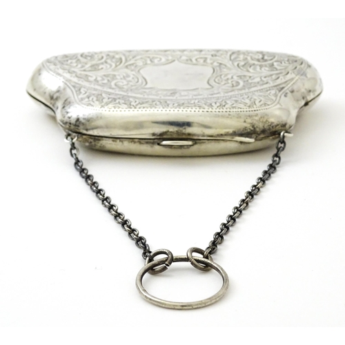 353 - A silver purse with engraved decoration and hanging chain, hallmarked Birmingham 1907. Approx. 4 1/2... 