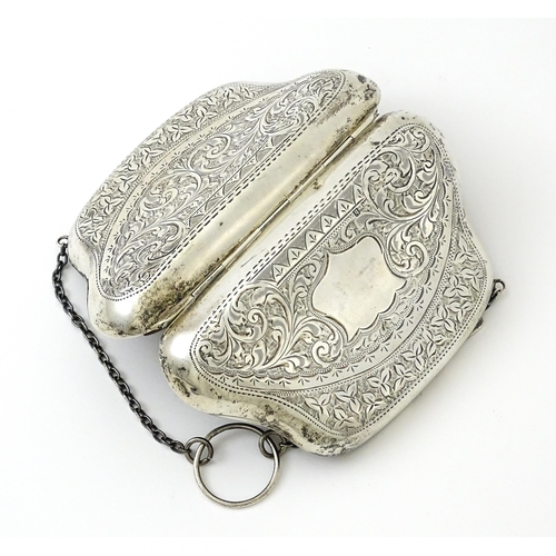 353 - A silver purse with engraved decoration and hanging chain, hallmarked Birmingham 1907. Approx. 4 1/2... 