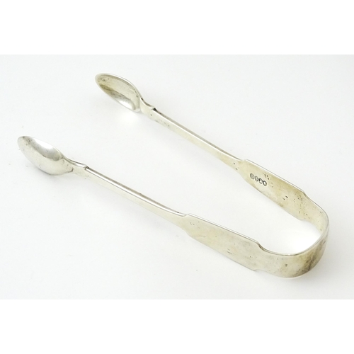 366 - Irish silver sugar tongs hallmarked Dublin 1824, bearing maker's marks for Christopher Eades and M. ... 