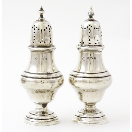 376 - A pair of silver pepperettes hallmarked Birmingham 1912, maker William Hutton & Sons Ltd. Approx. 4