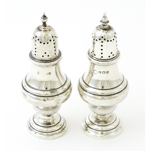 376 - A pair of silver pepperettes hallmarked Birmingham 1912, maker William Hutton & Sons Ltd. Approx. 4