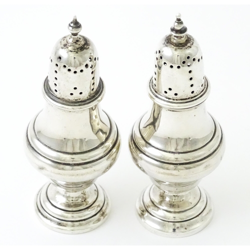 376 - A pair of silver pepperettes hallmarked Birmingham 1912, maker William Hutton & Sons Ltd. Approx. 4