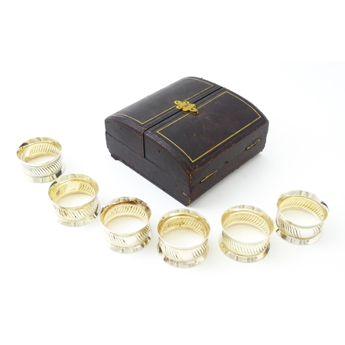 377 - A cased set of six silver plate napkin rings. Case approx. 5 1/2